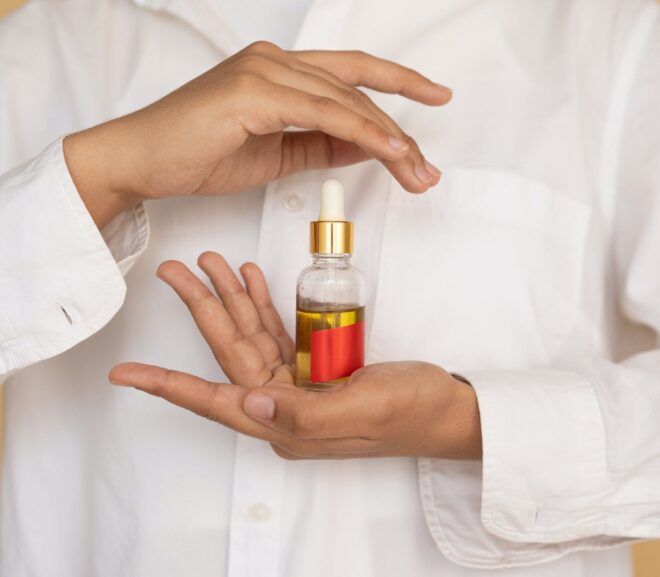 woman holding a bottle of essential oil
