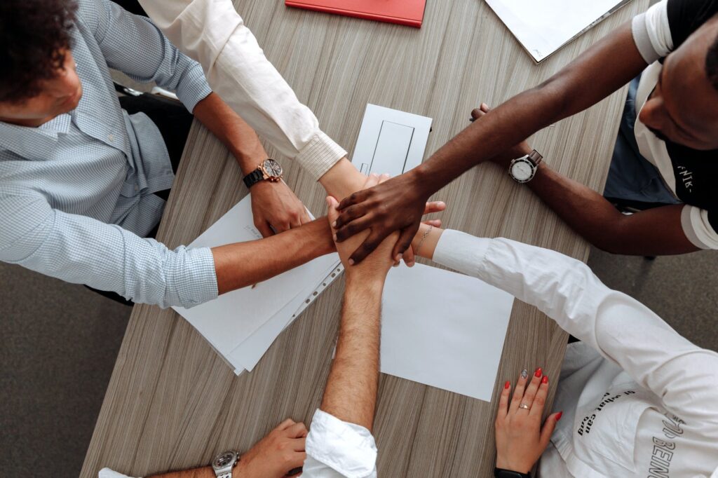man and woman holding each other s hands as a team, team work, good boss