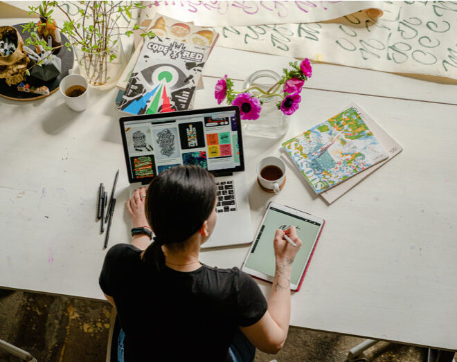 women sitting on desk