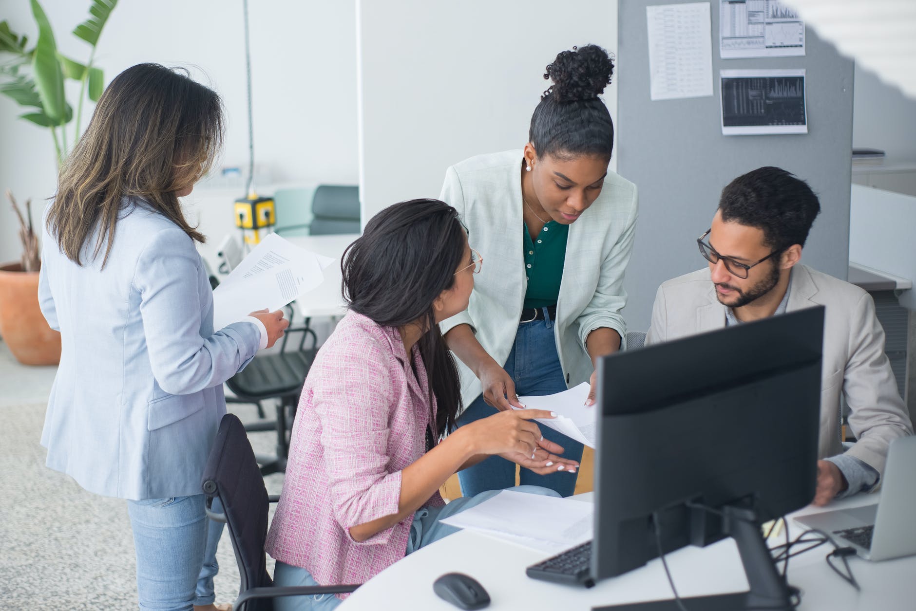 people in the office having a discussion, Icebreaker Questions to Connect With Your New Colleagues