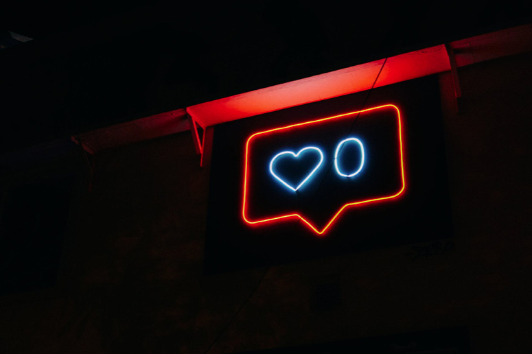 Instagram heart in neon lights next to a 0