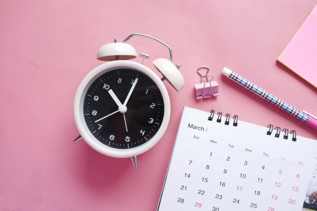 white and pink alarm clock