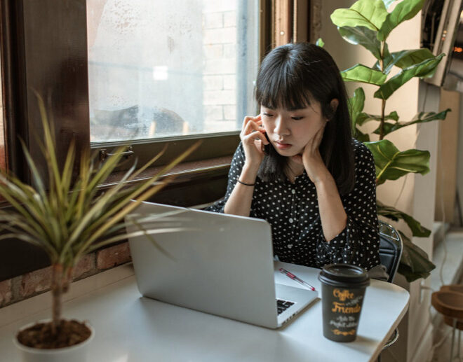 Women sitting on desk writing resume