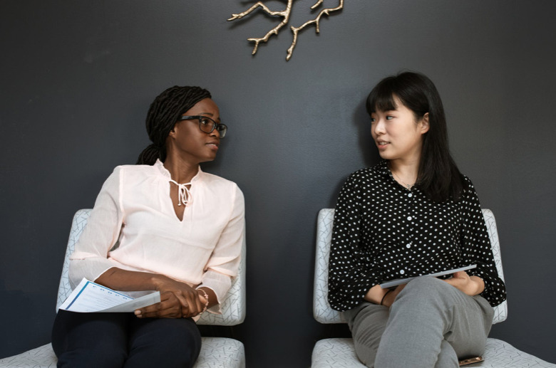 22 Things That Should Be on Your Resume. Two Women Sitting on Chairs talking.