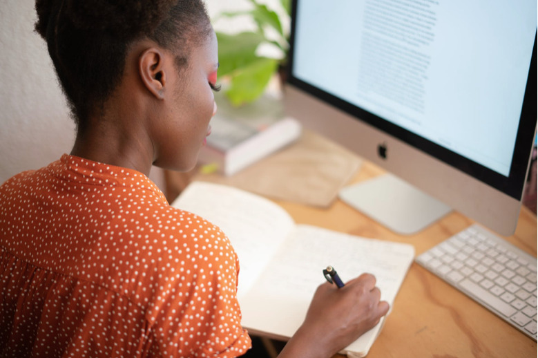 3 Things to Do with Your Dissertation that Nobody Tells You . Women sitting on desk.