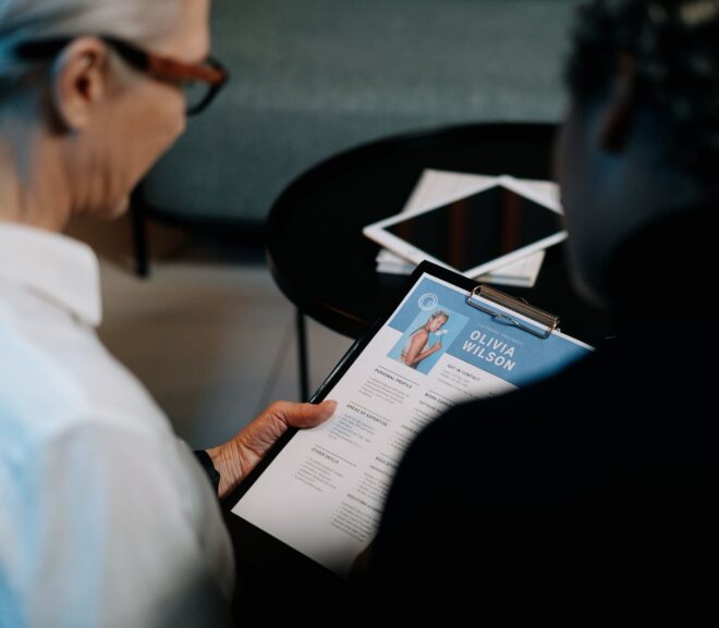 woman holding a clipboard with resume