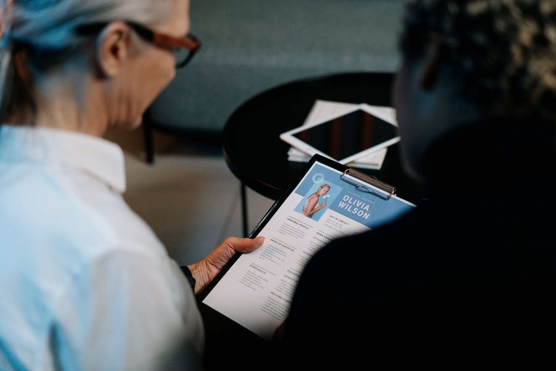 woman holding a clipboard with resume, job interview