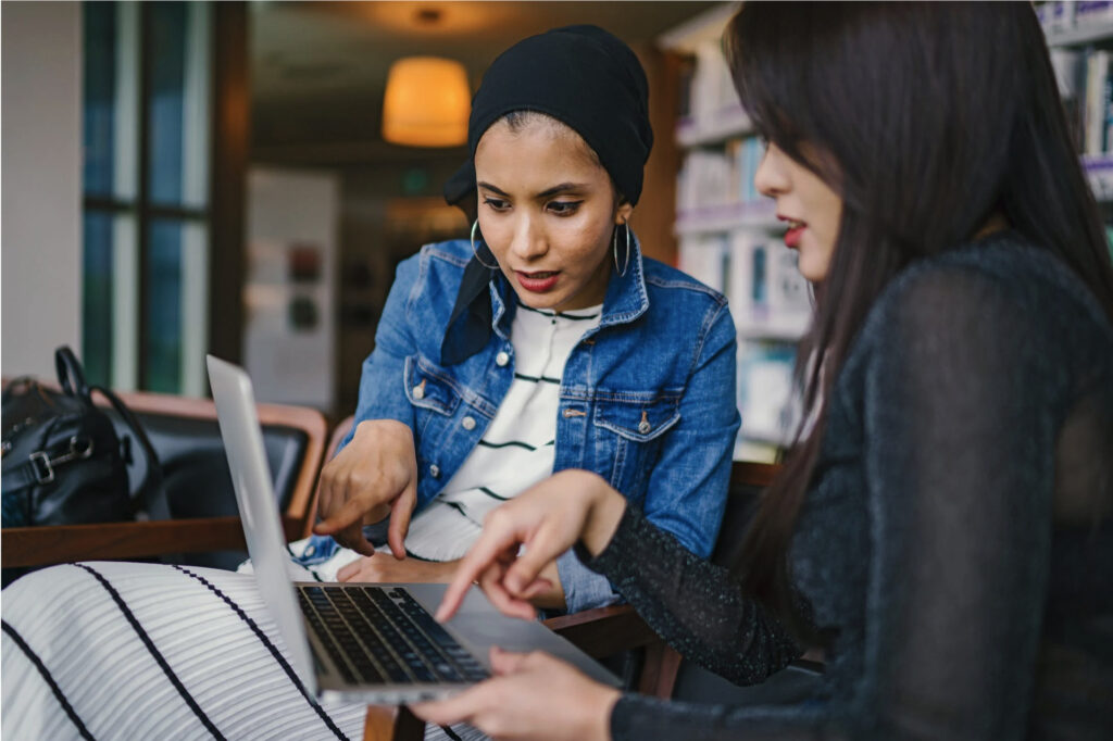 Two women looking at laptop