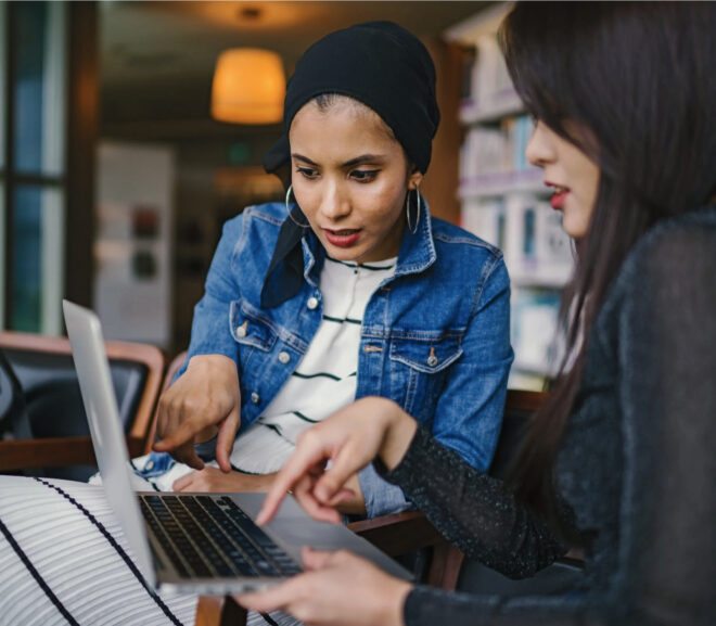 Two women looking at laptop