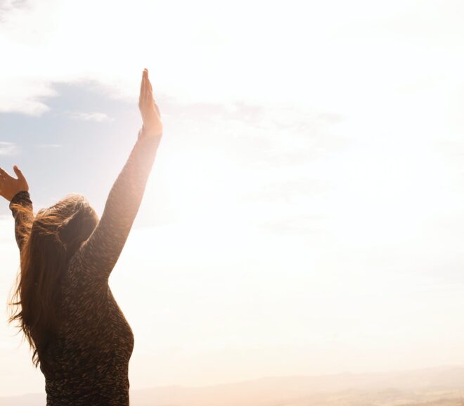 photo of woman raising both hands